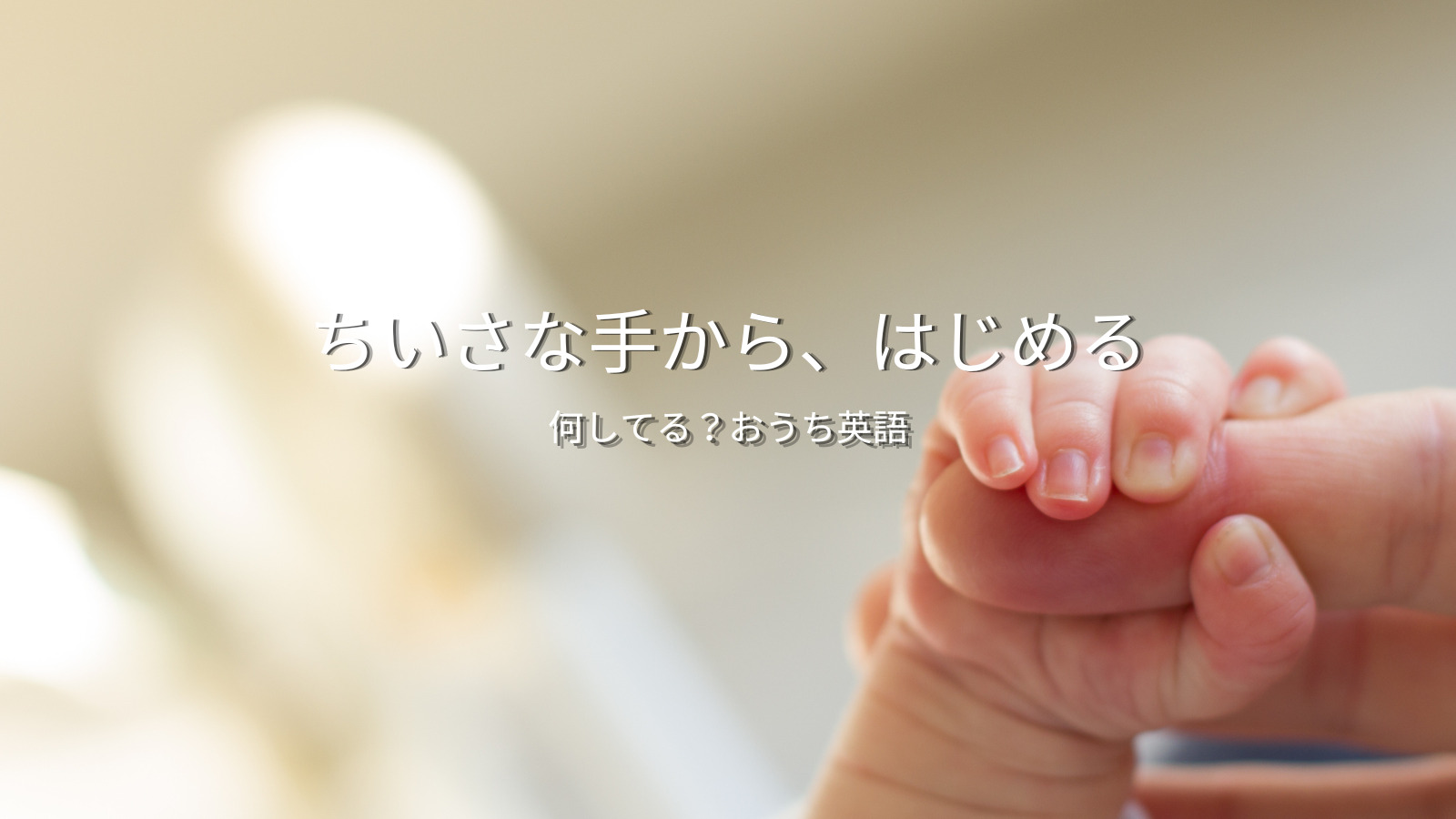 親の指を握る赤ちゃんの手と「ちいさな手から、はじめる」のキャッチコピー｜おうち英語